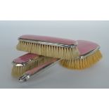 A pink enamelled three piece brush set. Birmingham