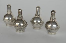 A heavy set of four Eastern pepper pots with ball