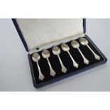 A boxed set of six silver trefid spoons with lace