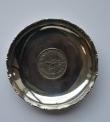 A small circular pin dish, inset with coin. Approx