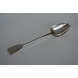 A heavy silver basting spoon of fiddle pattern des