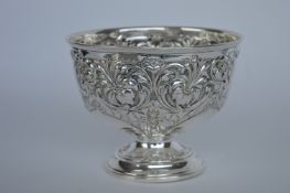 A heavy pedestal rose bowl with floral decoration.