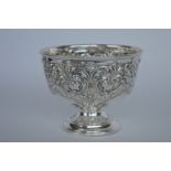 A heavy pedestal rose bowl with floral decoration.