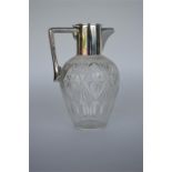 A silver mounted claret jug with hinged top. Birmi