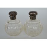 A pair of silver scent bottles with hinged top. Bi