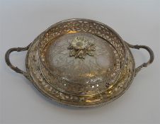 An attractive bright cut butter dish with beaded rim and pierced decoration, (liner missing).