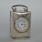An attractive rectangular silver carriage clock on four ball feet with white enamelled dial and