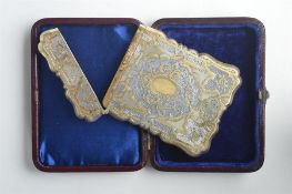 A good quality silver gilt card case in leather case, the body attractively decorated with flowers