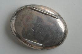 An oval silver tobacco pouch with hinged top and gilt interior. Birmingham. By D&F. Approx. 62
