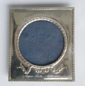 A rectangular picture frame with bow decoration. Approx. 12.5 cms high. Est. £100 - £150.