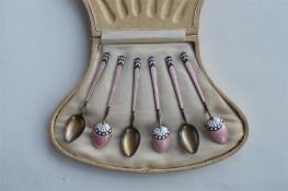 An attractive cased set of six Continental enamelled teaspoons. Est. £40 - £60.