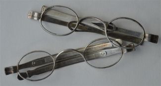 A pair of unusual silver spectacles with hinged de