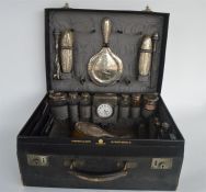 A good leather cased travelling dressing case with fitted interior containing brushes, hip flasks,