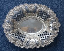 A large oval pierced dish with embossed decoration