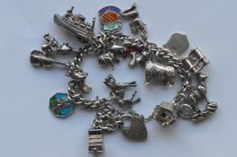 A heavy silver charm bracelet with ring clasp. App