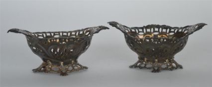 A good pair of pierced bonbon dishes with scroll decoration. London. By WH&W. Est. £30 - £50.