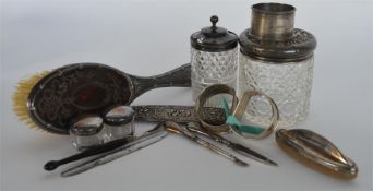 A box containing silver napkin rings, a dressing t