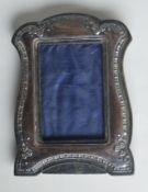 A small wavy edged picture frame, the border decorated with flowers and leaves. Birmingham. By JD&