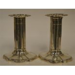 A good pair of piano candlesticks with wavy edge.