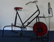 An unusual exercise bike with chrome handlebars. B