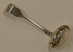 A Victorian sugar sifting spoon. Sheffield 1859. B