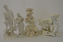A collection of four decorative white figures. Est