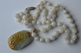 A good Chinese jade panel with gold loop top toget