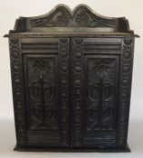 A continental oak hanging hall cupboard with carve