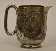 An attractive Victorian engraved cream jug on pede
