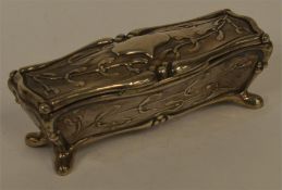 A stylish trinket box moulded with leaves and scro
