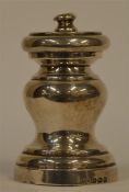 A silver pepper grinder of turned form. Birmingham