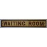 A cast iron door sign, "Waiting Room". Painted cre