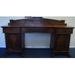 A large mahogany breakfront sideboard with bead wo