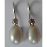 A pair of attractive pearl and diamond drop earrin