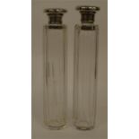 A pair of silver top tubular scent bottles with hi