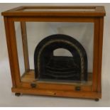 A miniature cast iron model of a fire grate and su