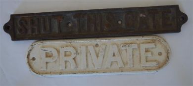 Two cast iron signs, the first "Shut this gate", a