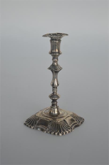 A Georgian style cast taper candlestick with shell