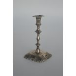 A Georgian style cast taper candlestick with shell
