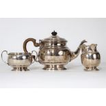 A heavy three piece tea service of circular form.