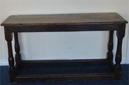 An Antique oak rectangular table with stretcher ba