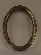 A good quality oval picture frame with oak panelle
