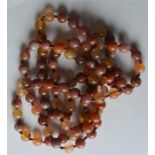 A heavy string of agate beads with gold clasp. Est