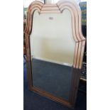 A large stylish oval mantle mirror with wavy top.