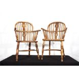 A matched pair of bow back chairs on turned suppor