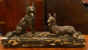 A large marble mounted figure of two Alsatians in