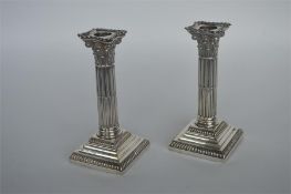 A pair of good Corinthian column candlesticks on s