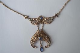 A stylish gold Arts & Crafts sapphire and half pea
