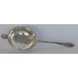 A small stylish tea strainer with shell thumb piec