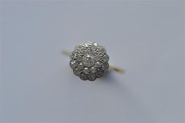 A circular diamond multi stone set cluster ring in